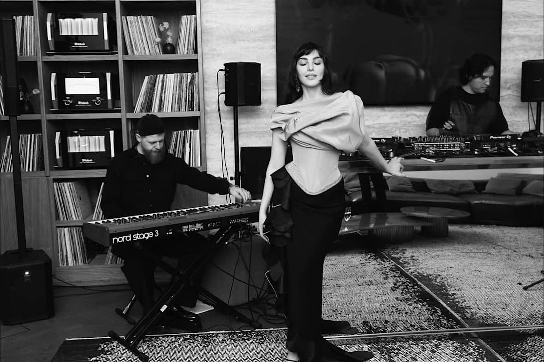 Manou standing at piano